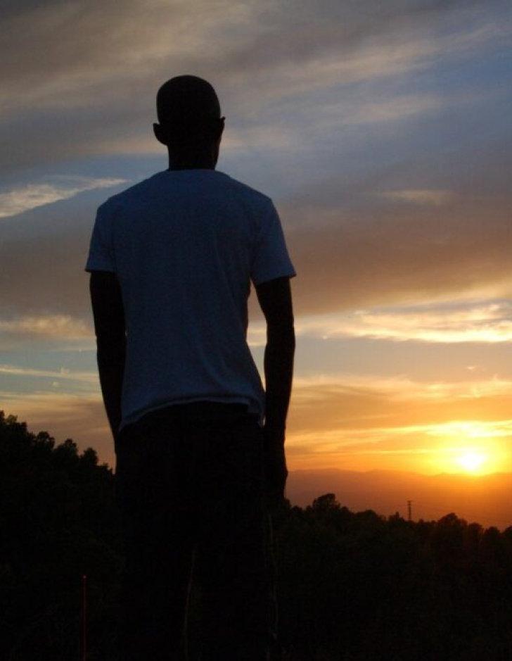 silhouette of a man looking into the sunset